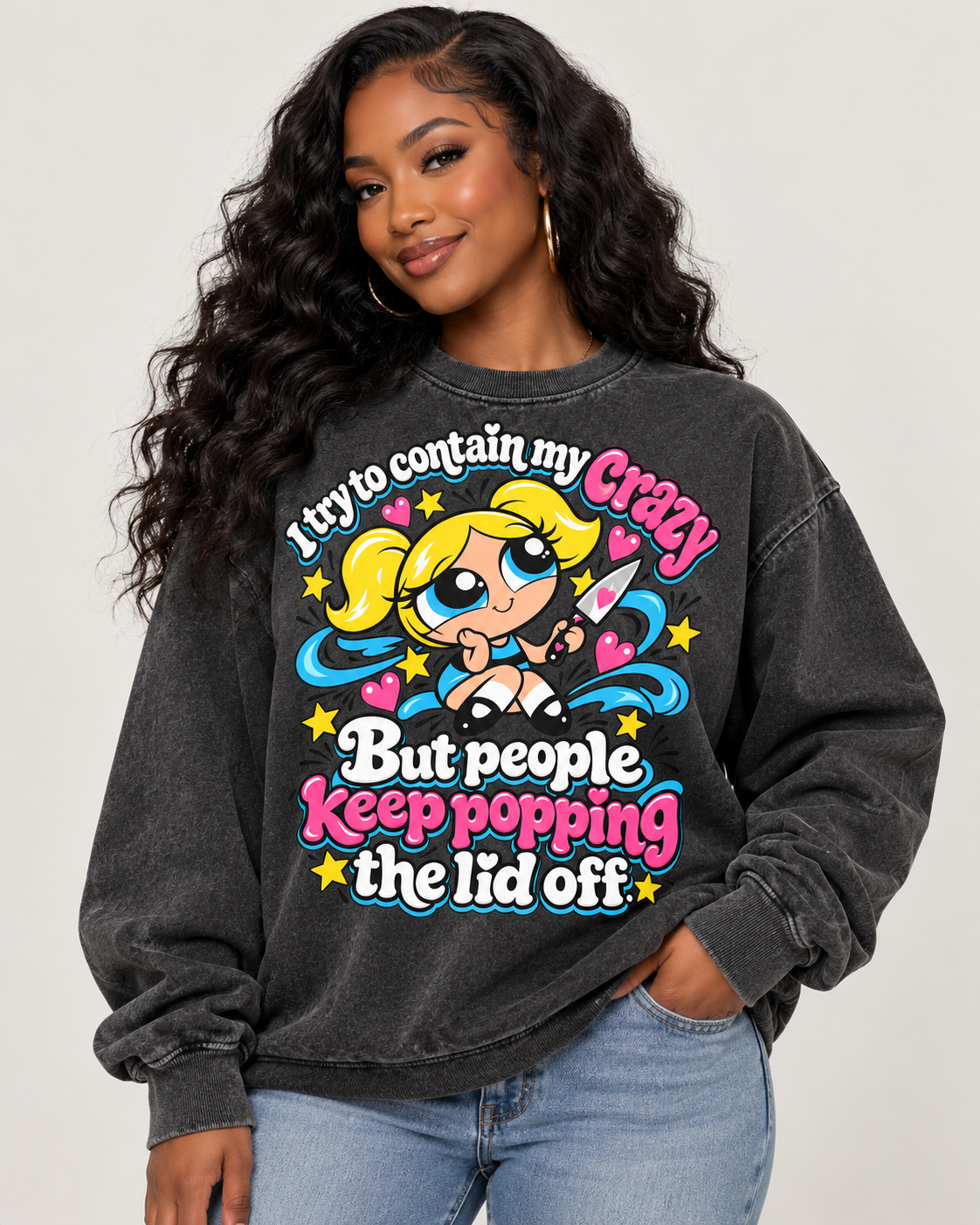 Comfort Colors Pepper crewneck sweatshirt featuring a colorful cartoon girl with pink, blue, and yellow accents and the saying "I Try to Contain My Crazy, But People Keep Popping the Lid Off."