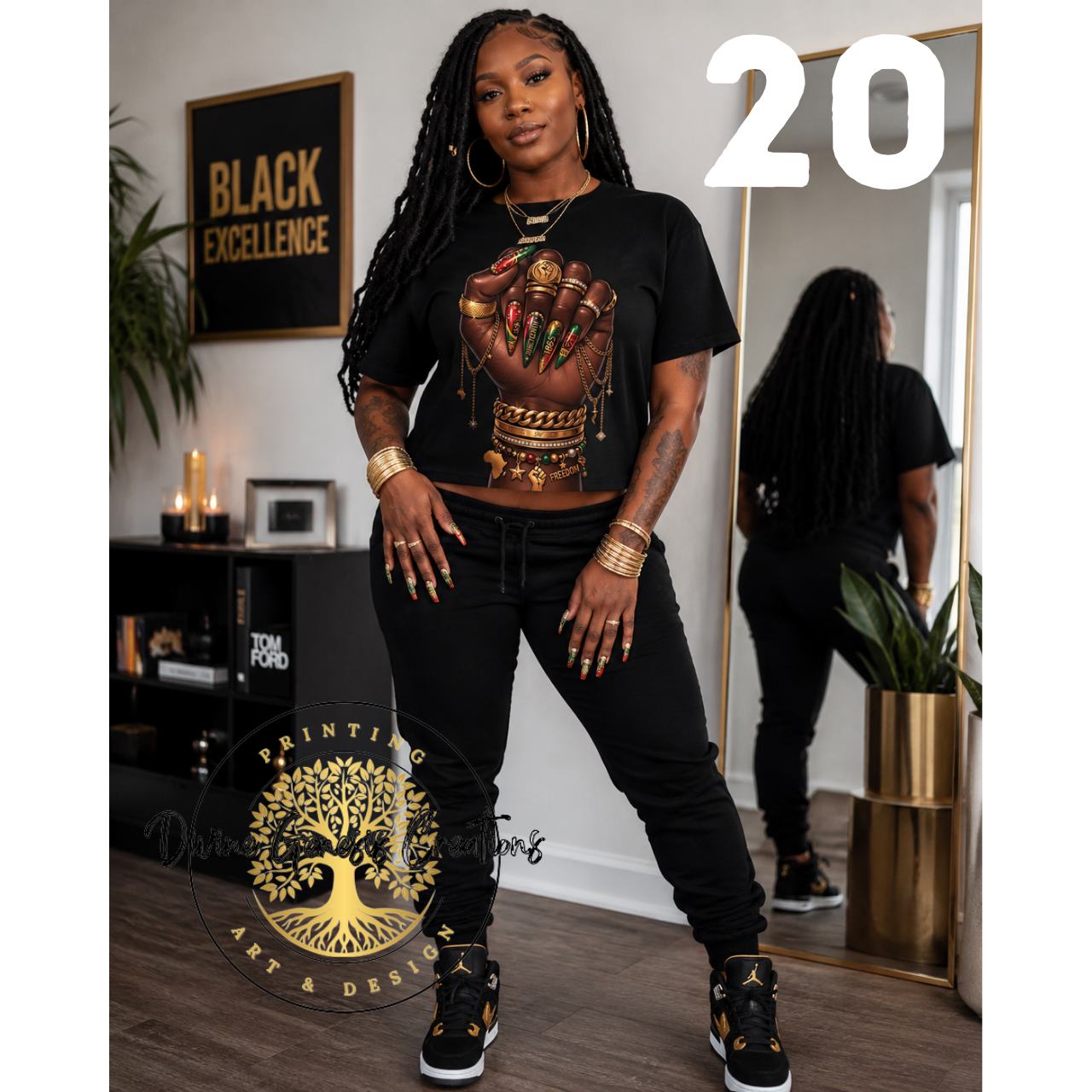 Person wearing a black t-shirt with a graphic design, standing in a room with decor elements.