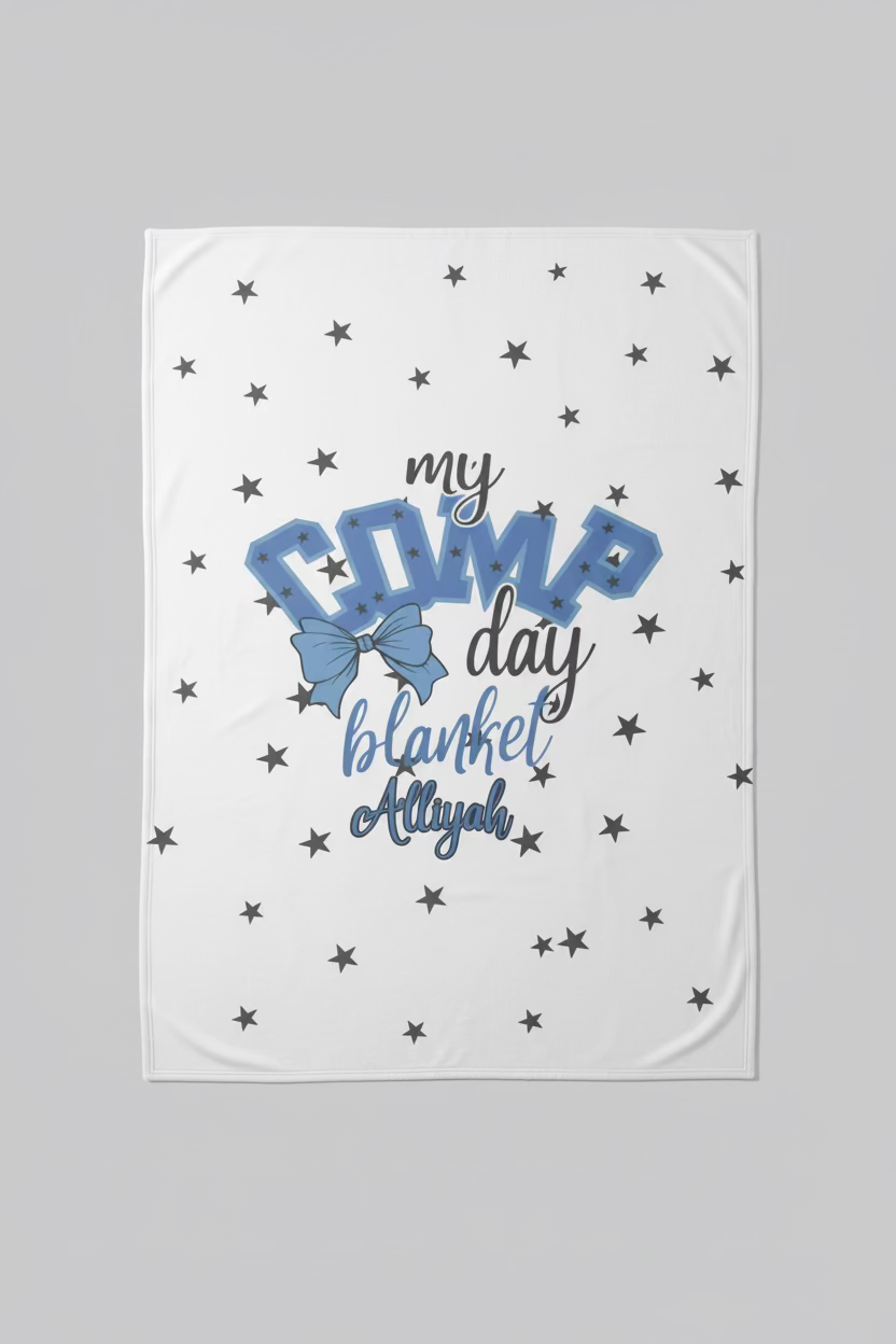 White blanket with blue text and stars on a wooden surface