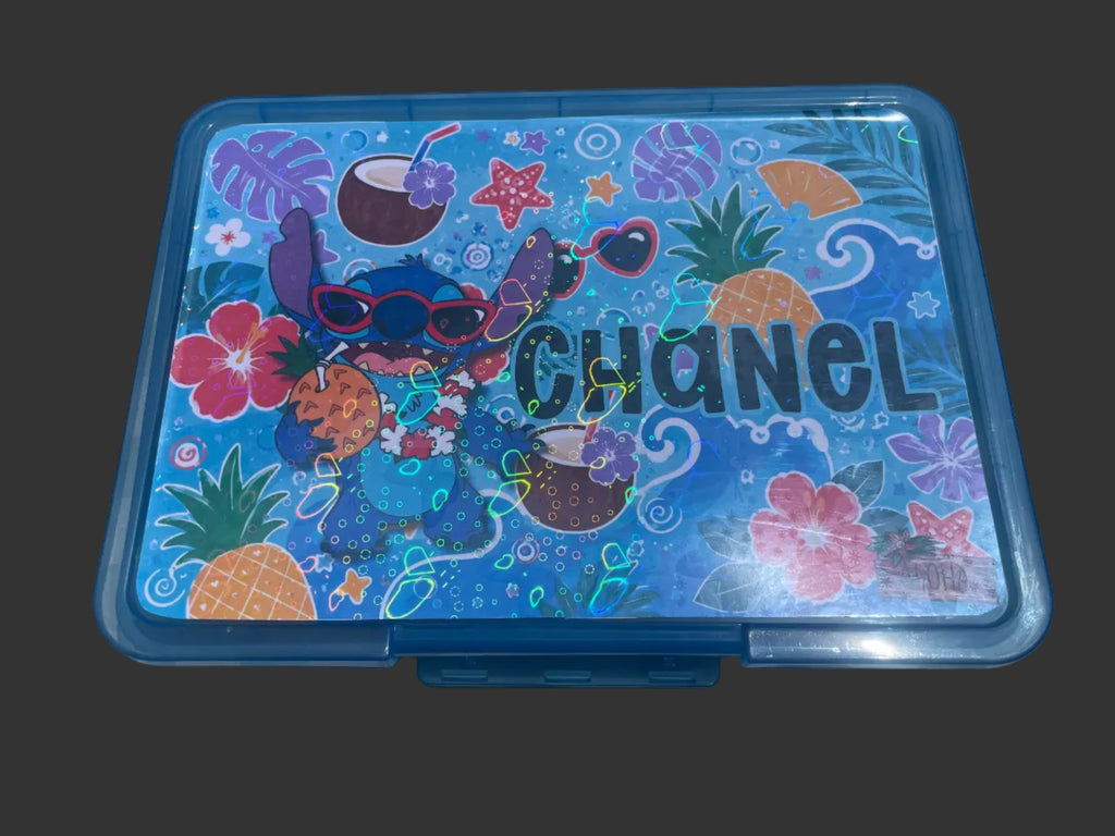 A blue plastic school supply box with a colorful tropical-themed sticker design.