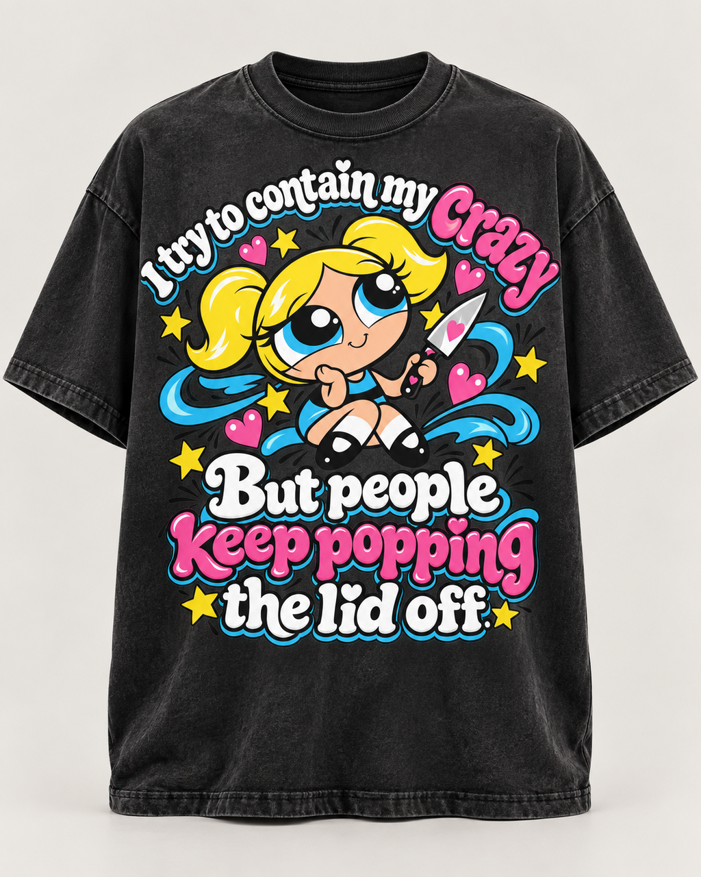 Washed black oversized graphic T-shirt mockup with bright pink, blue, yellow and white lettering reading I try to contain my crazy but people keep popping the lid off